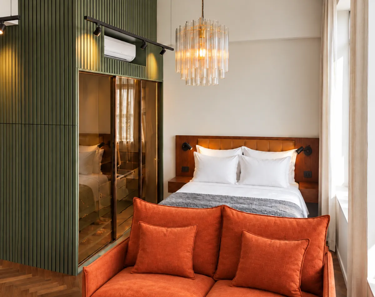 Luxury long stay Sao Paulo, bedroom with green fluted wardrobe, upholstered headboard and reading lights